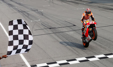 FILE PHOTO: Honda MotoGP rider Marc Marquez of Spain celebrates as he wins the Malaysian Motorcycle Grand Prix at Sepang International Circuit near Kuala Lumpur October 26, 2014. REUTERS/Olivia Harris/File Photo