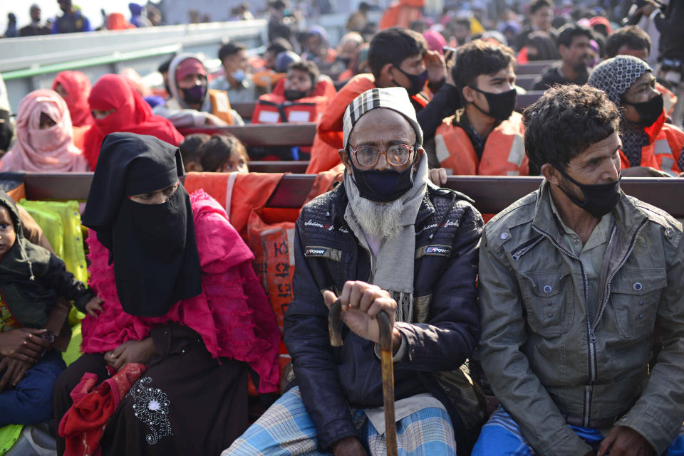 Rohingya refugees wait in a naval ship to be transported to an isolated island in the Bay of Bengal, in Chittagong, Bangladesh, Tuesday, Dec. 29, 2020. Officials in Bangladesh sent a second group of Rohingya refugees to the island on Monday despite calls by human rights groups for a halt to the process. The Prime Minister’s Office said in a statement that more than 1,500 Rohingya refugees left Cox’s Bazar voluntarily under government management. Authorities say the refugees were selected for relocation based on their willingness, and that no pressure was applied on them. But several human rights and activist groups say some refugees have been forced to go to the island, located 21 miles (34 kilometers) from the mainland. (AP Photo/Mahmud Hossain Opu)