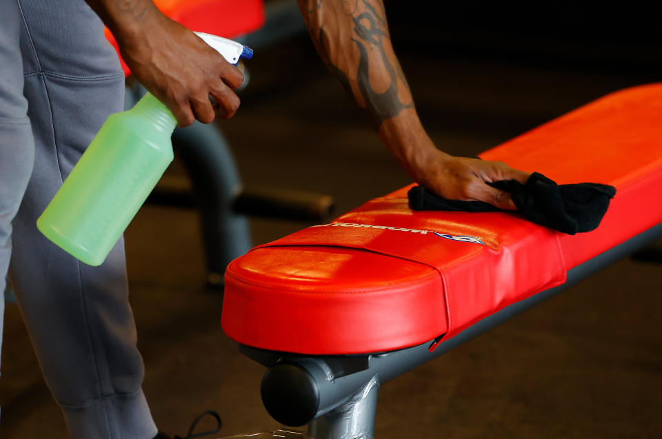 Army Vet Valentino Murray cleans a bench before using it at Workout Anytime Powder Springs gym on April 24, 2020, in Powder Springs, Georgia, after gyms in the state reopened.  (Photo: Kevin C. Cox/Getty Images)