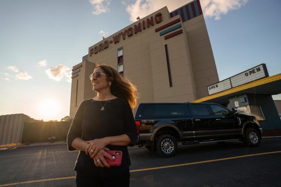 Lynette LaPointe, of Livonia, poses for a photo after exiting her truck to take photos of signs and structures at the Ford-Wyoming Drive-In in Dearborn on Thursday, July 18, 2024. LaPointe has visited all of the operational and closed drive-ins in Michigan and surrounding states regularly documenting them while enjoying the nostalgia and being outside. "I want to keep this place going. So we try to come as often as we can," said LaPointe, who has been to the drive-in that operates for 12 months many times through rain, sleet and snow.