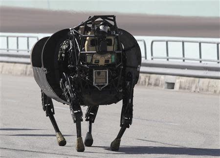 An LS 3 (Legged Squad Support System) robot demonstrates its movement, showing it is designed to accompany soldiers and Marines any place they go on foot, helping to carry their gear, during a demonstration in Homestead, Florida December 20, 2013. REUTERS/Andrew Innerarity