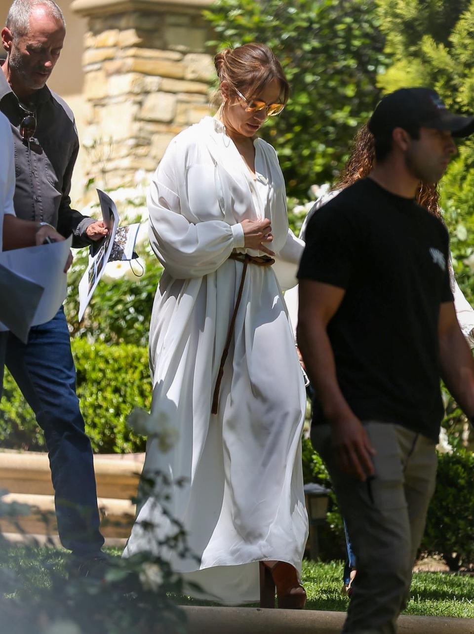 <p>Shortly after announcing her engagement to Ben Affleck, J-Lo was spotted house hunting in Los Angeles wearing the ultimate summer look: a white, flowy maxi dress paired with a braided belt, brown suede Aquazzura platform sandals and some mega sunglasses. </p><p><a class="link " href="https://www.net-a-porter.com/en-gb/shop/designer/aquazzura" rel="nofollow noopener" target="_blank" data-ylk="slk:SHOP AQUAZZURA;elm:context_link;itc:0;sec:content-canvas">SHOP AQUAZZURA</a></p>