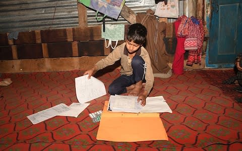 Zeeshan with his school work and medicine - Credit: Joe Wallen