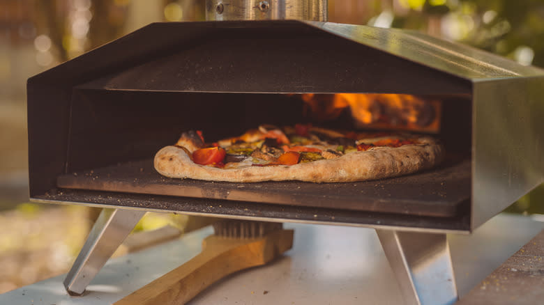 Pizza cooking inside portable oven