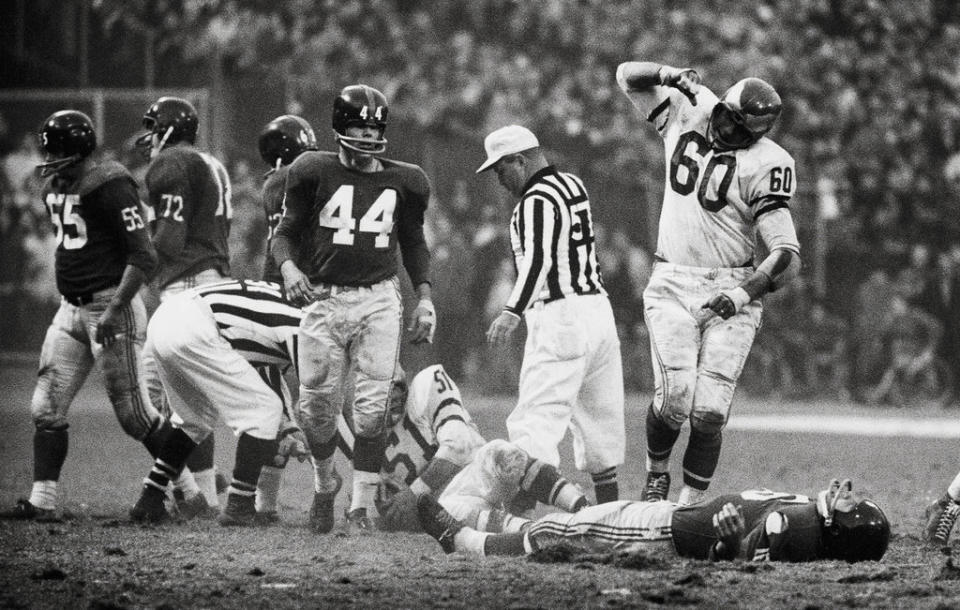 Chuck Bednarik stands over Frank Gifford.