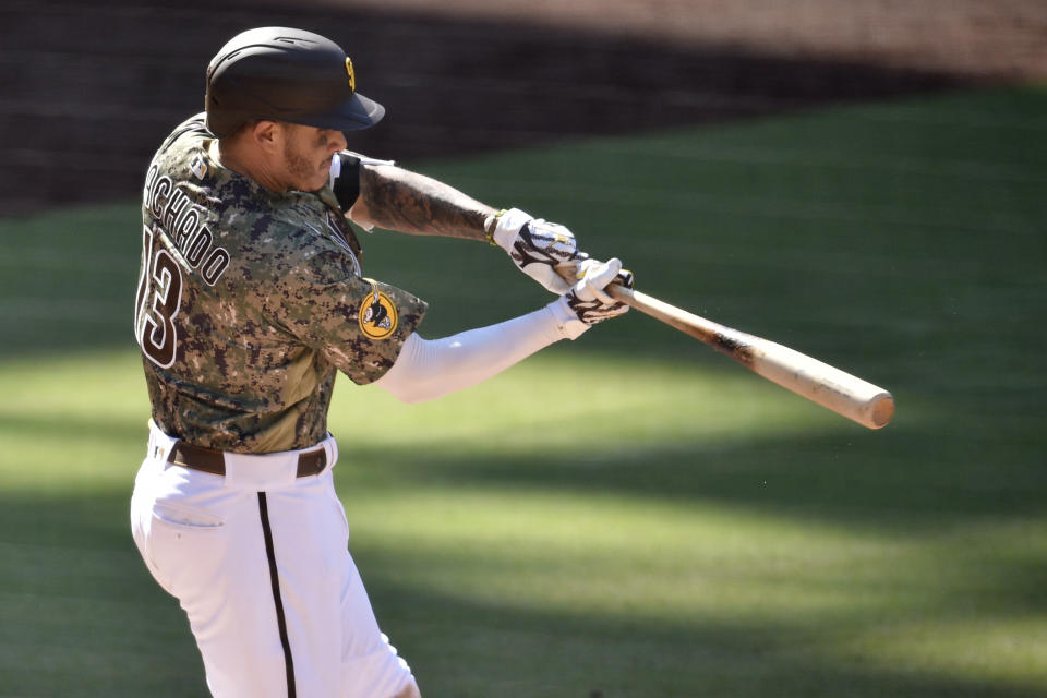 San Diego Padres' Manny Machado hits a two-run home run during the eighth inning of a baseball game against the Houston Astros in San Diego, Sunday, Aug. 23, 2020. (AP Photo/Kelvin Kuo)