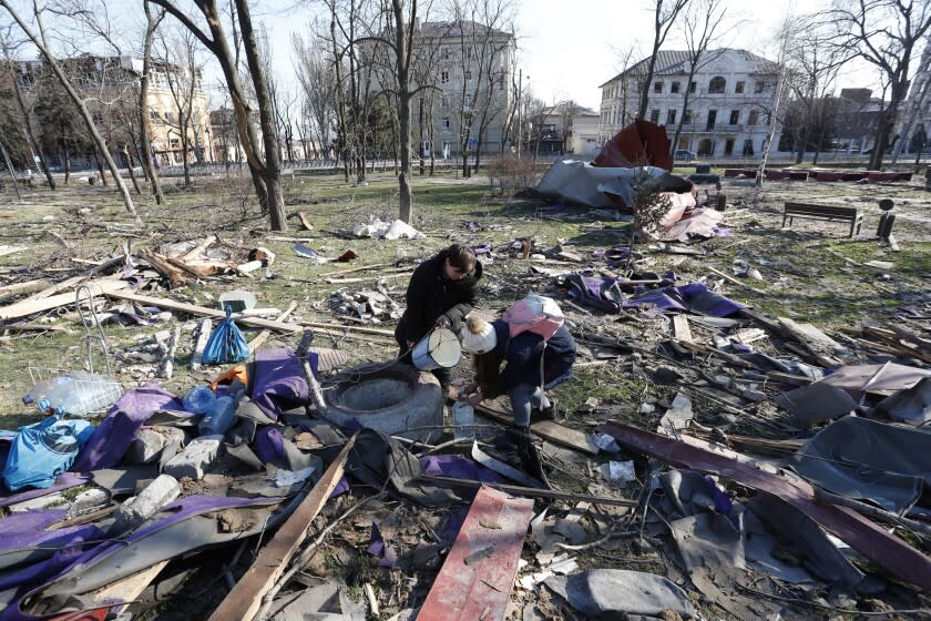 Local residents draw water from a well in Mariupol, April 7, 2022. (Photo by Victor/Xinhua via Getty Images)