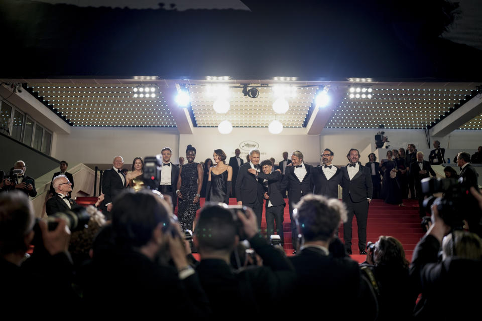 Producer Frank Marshall, from left, producer Kathleen Kennedy, Boyd Holbrook, Shaunette Renee Wilson, Phoebe Waller-Bridge, Harrison Ford, Ethann Isidore, Mads Mikkelsen, director James Mangold and producer Simon Emanuel pose for photographers upon departure from the premiere of the film 'Indiana Jones and the Dial of Destiny' at the 76th international film festival, Cannes, southern France, Thursday, May 18, 2023. (Photo by Scott Garfitt/Invision/AP)