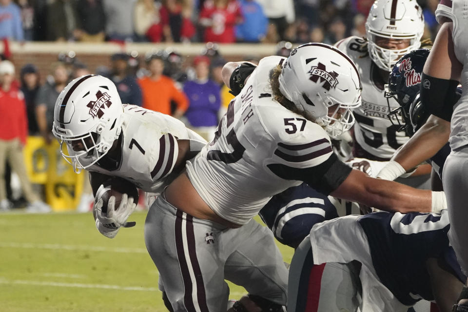 Mississippi State running back Jo'quavious Marks (7) follows the block of offensive lineman Cole Smith (57) for a 1-yard touchdown during the first half of the team's NCAA college football game against Mississippi in Oxford, Miss., Thursday, Nov. 24, 2022. (AP Photo/Rogelio V. Solis)