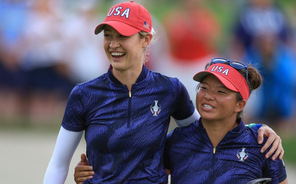 Megan Khang (R) and Nelly Korda of The United States Team celebrate as they leave the 14th green after winning their match by 6&4 against Georgia Hall and Leona Maguire of The European Team during the afternoon four ball matches of the Solheim Cup 2024 at Robert Trent Jones Golf Club on September 13, 2024 in Gainesville, Virginia