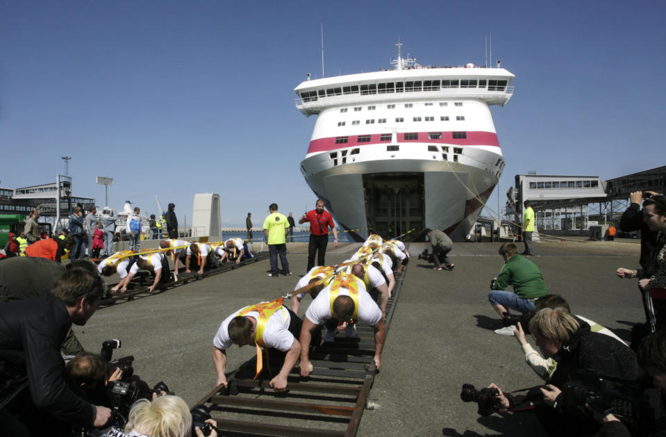 Estonia's strong man team pulls "Baltic Queen", a 21746 ton passenger ferry, in Tallinn May 20, 2011. The athletes set a new world record for the heaviest weight pulled by manpower, organizers said. REUTERS/Ints Kalnins