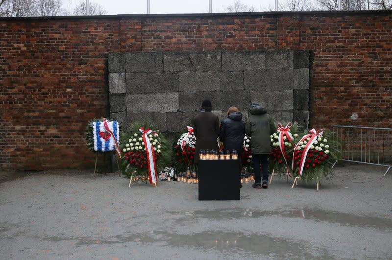 Mourners stand before the Wall of Death during a ceremony at the site of the former Auschwitz-Birkenau Nazi concentration and extermination camp in Oswiecim, Poland, on Saturday, marking the 79th anniversary of its liberation. Photo by Jarek Praszkiewicz/EPA-EFE