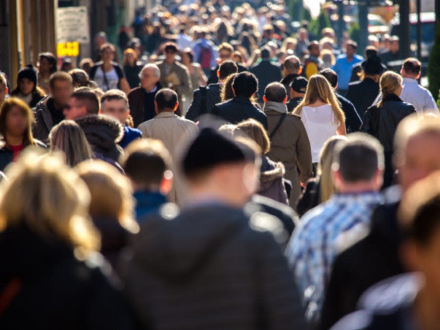 A crowd of people walking in New York City.