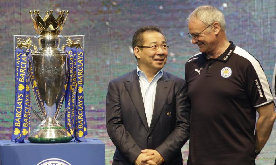 Leicester City’s chairman, Vichai Srivaddhanaprabha, left, talks to Claudio Ranieri beside the Premier League trophy.