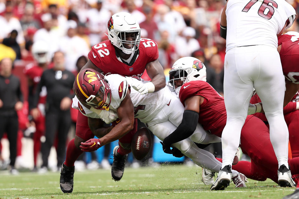 Antonio Gibson #24 of the Washington Commanders fumbles the ball while being tackled by <a class="link " href="https://sports.yahoo.com/nfl/players/33598" data-i13n="sec:content-canvas;subsec:anchor_text;elm:context_link" data-ylk="slk:Victor Dimukeje;sec:content-canvas;subsec:anchor_text;elm:context_link;itc:0">Victor Dimukeje</a> #52. (Photo by Scott Taetsch/Getty Images)