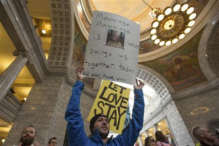 Marcel Gaztambide holds a sign to support same-sex marriage during a rally at the state capitol in Salt Lake City, Utah January 10, 2014. REUTERS/Sallie Dean Shatz