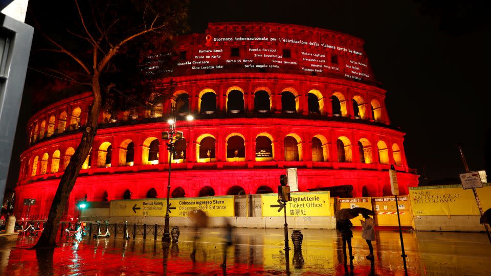 Names of femicide victims are projected onto the Colosseum lit up in red to honor women who have been killed by men to mark International Day for the Elimination of Violence Against Women, in Rome, Italy, on November 25, 2021. - Remo Casilli/Reuters