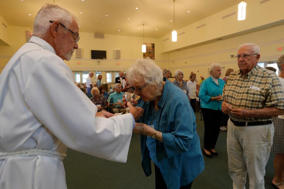 Members of SanibelÕs St. Michael & All Angels Church gather during Palm Sunday on April 2, 2023, at Fort Myers' Peace Lutheran Church. The congregation has had to conduct services at a different location after their Sanibel building was badly damaged by Hurricane Ian last year.