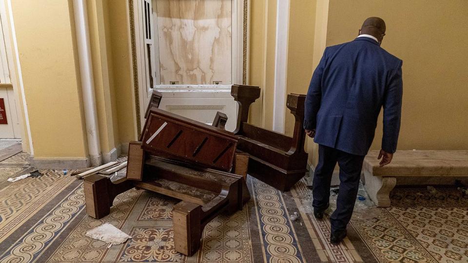 Sen. Tim Scott, R-S.C., stops to look at damage in the early morning hours of Thursday, Jan. 7, 2021, after protesters stormed the Capitol in Washington, on Wednesday.