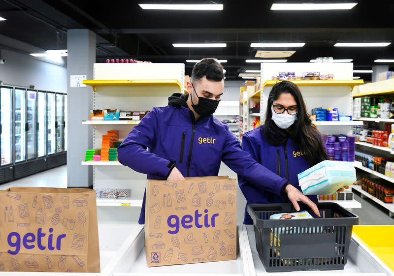 FILE PHOTO: Order pickers work at a dark store of the fast grocery deliverer Getir