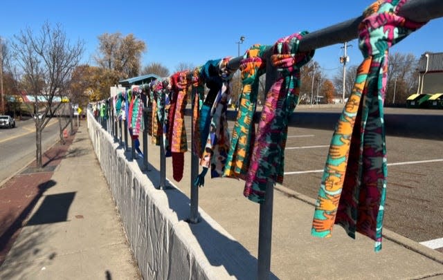 Scarves are seen tied to a fence at South Union Avenue and East Main Street as part of The Scarf Project giveaway event on Nov. 10, 2023. Twenty-five locations around northern Ohio had free items such as scarves, hats and gloves tied to fences or posts, left for those who need help staying warm during the cold weather.