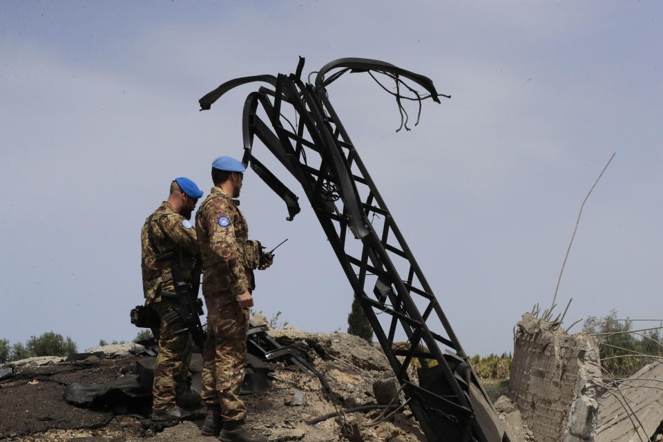 Italian U.N. peacekeeper soldiers inspect a small bridge that was destroyed by an Israeli airstrike, in Maaliya village, south Lebanon, Friday, April 7, 2023. Israel launched rare strikes in southern Lebanon early Friday and pressed on with bombing targets in the Gaza Strip, marking a widening escalation in the region following violence this week at Jerusalem's most sensitive holy site. Friday's strikes in southern Lebanon came a day after militants fired nearly three dozen rockets from there at Israel. (AP Photo/Mohammed Zaatari)