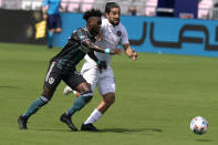 LA Galaxy defender Oniel Fisher, left, and Inter Miami midfielder Rodolfo Pizarro go for the ball during the first half of an MLS soccer match, Sunday, April 18, 2021, in Fort Lauderdale, Fla. (AP Photo/Lynne Sladky)