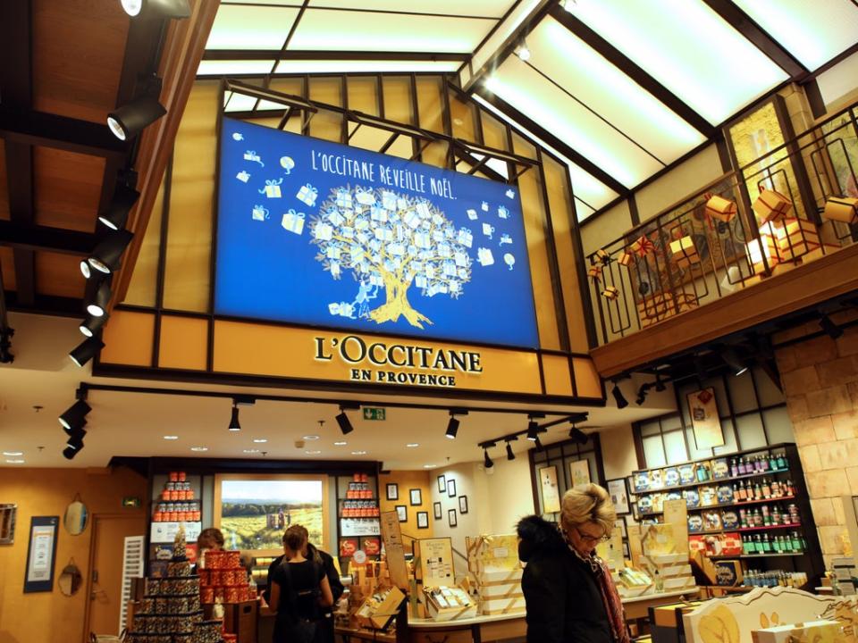 Customers shop in a store of French cosmetics company L'Occitane (AFP via Getty Images)