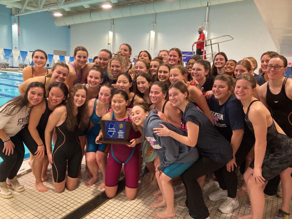 The Chatham girls swim team celebrates after defeating Summit to win the NJSIAA Public 2-B trophy.