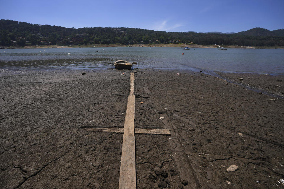 A boat sits on the exposed banks of the Miguel Aleman dam in Valle de Bravo, Mexico, Thursday, March 14, 2024. According to Mexico’s National Water Commission, Valle de Bravo’s reservoir has fallen to 29% of its capacity – a historical low -- compared to one year ago when it was at 52%, while the country endures a drought and has imposed restrictions on water taken from the system. (AP Photo/Marco Ugarte)