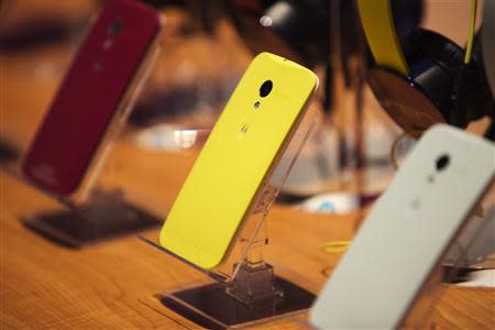 Different colored examples of Motorola's new Moto X phones rest on a table at a launch event in New York, in this August 1, 2013 file photo. REUTERS/Lucas Jackson/Files