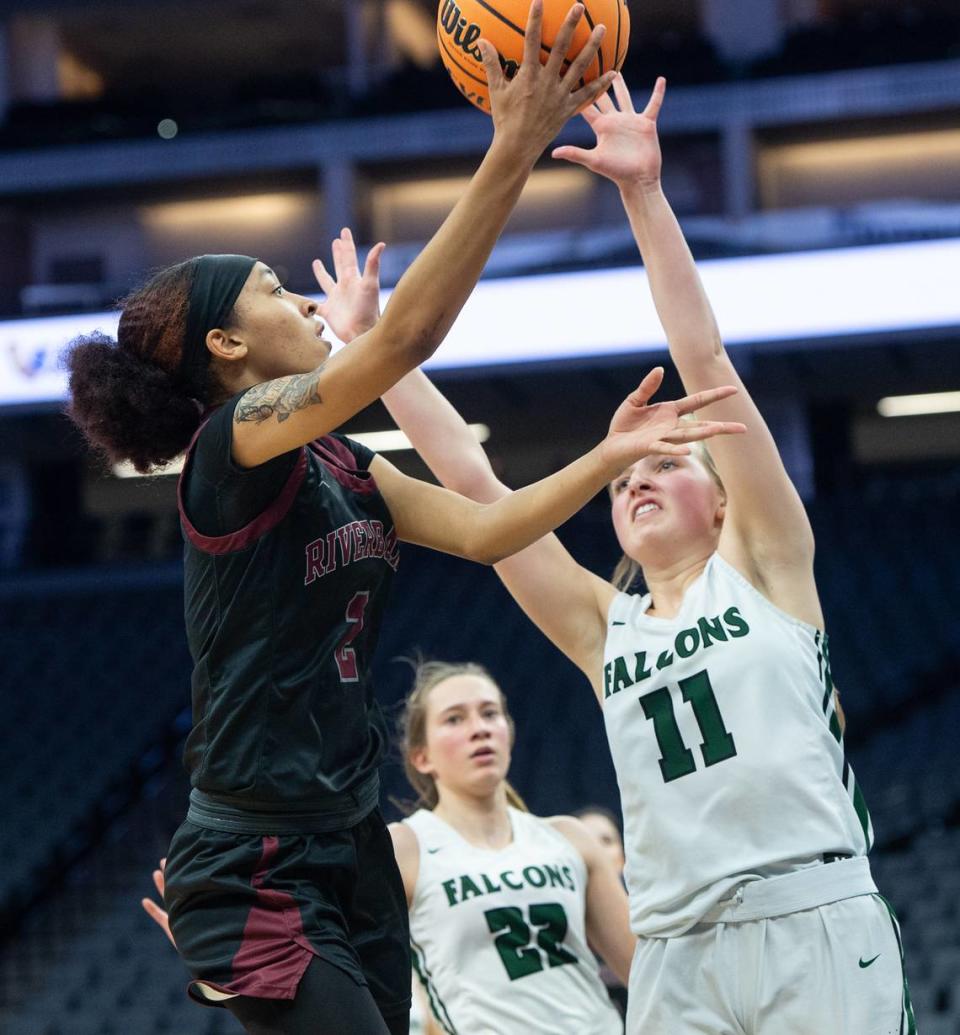 Riverbank’s Taylor Macias scores on a layup as Colfax’s Grace Clark defends during the Sac-Joaquin Section Division IV championship game at Golden 1 Center in Sacramento, Calif., Friday, Feb. 24, 2023.