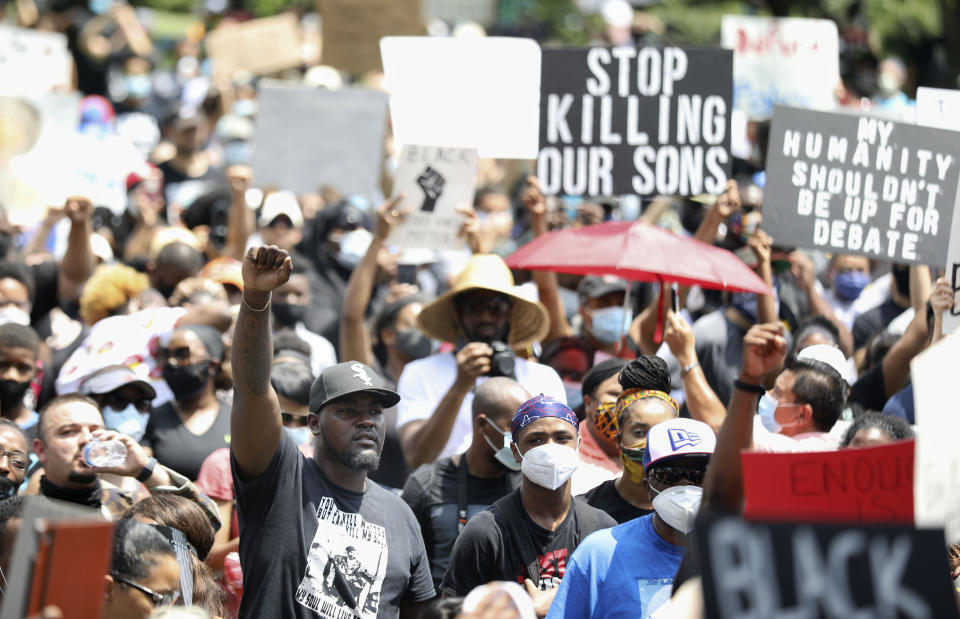 People join George Floyd's family in a march on Tuesday, June 2, 2020, from Discovery Green to City Hall in downtown Houston. Floyd died after being restrained by Minneapolis police officers on May 25. (Jon Shapley/Houston Chronicle via AP)