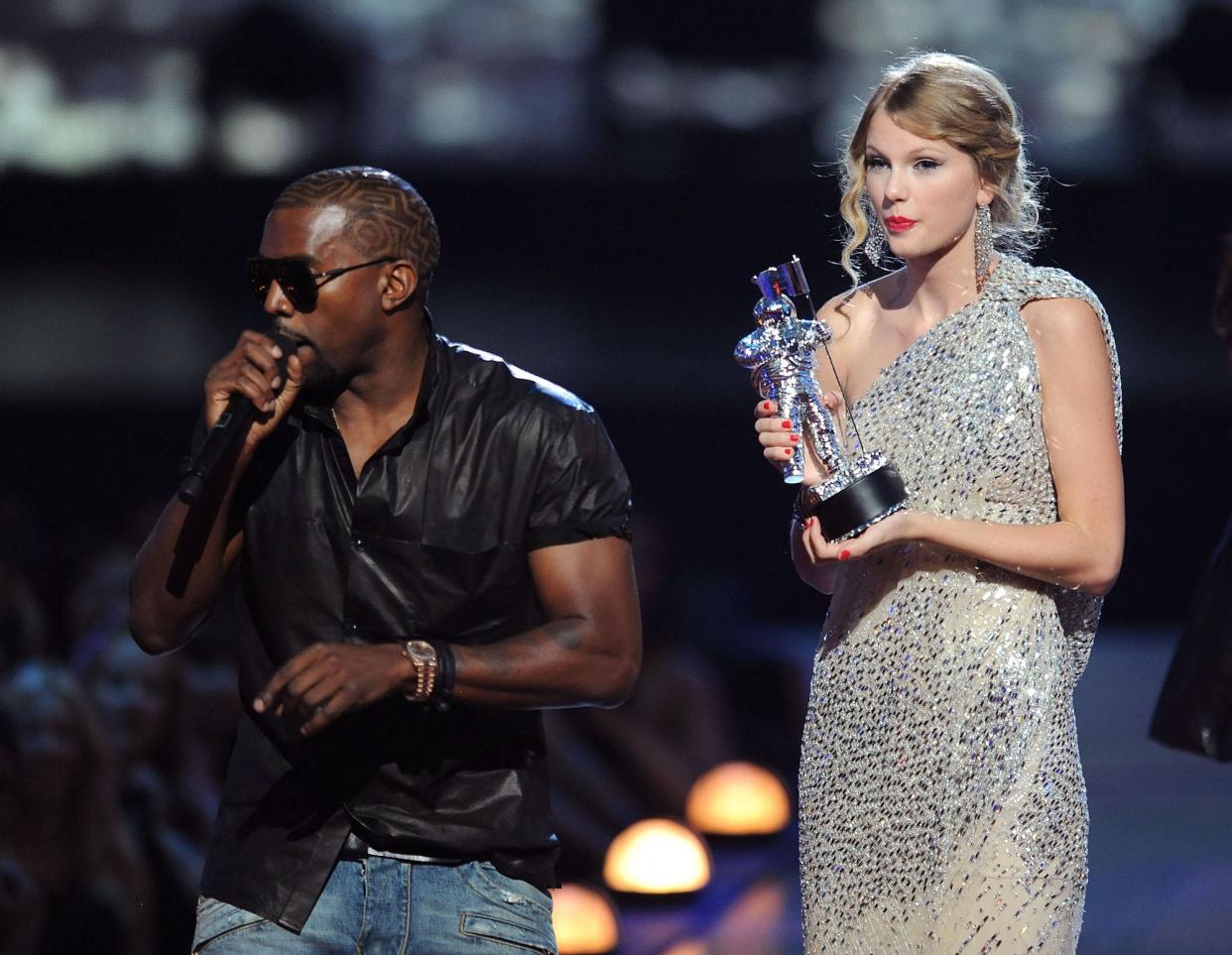 Kanye West takes the microphone from Taylor Swift and speaks onstage during the 2009 MTV Video Music Awards at Radio City Music Hall on September 13, 2009 in New York City.