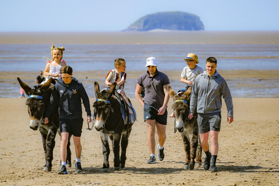 Donkey rides are popular on Weston’s beach where swimming is advised against due to the poor quality of bathing water (PA)