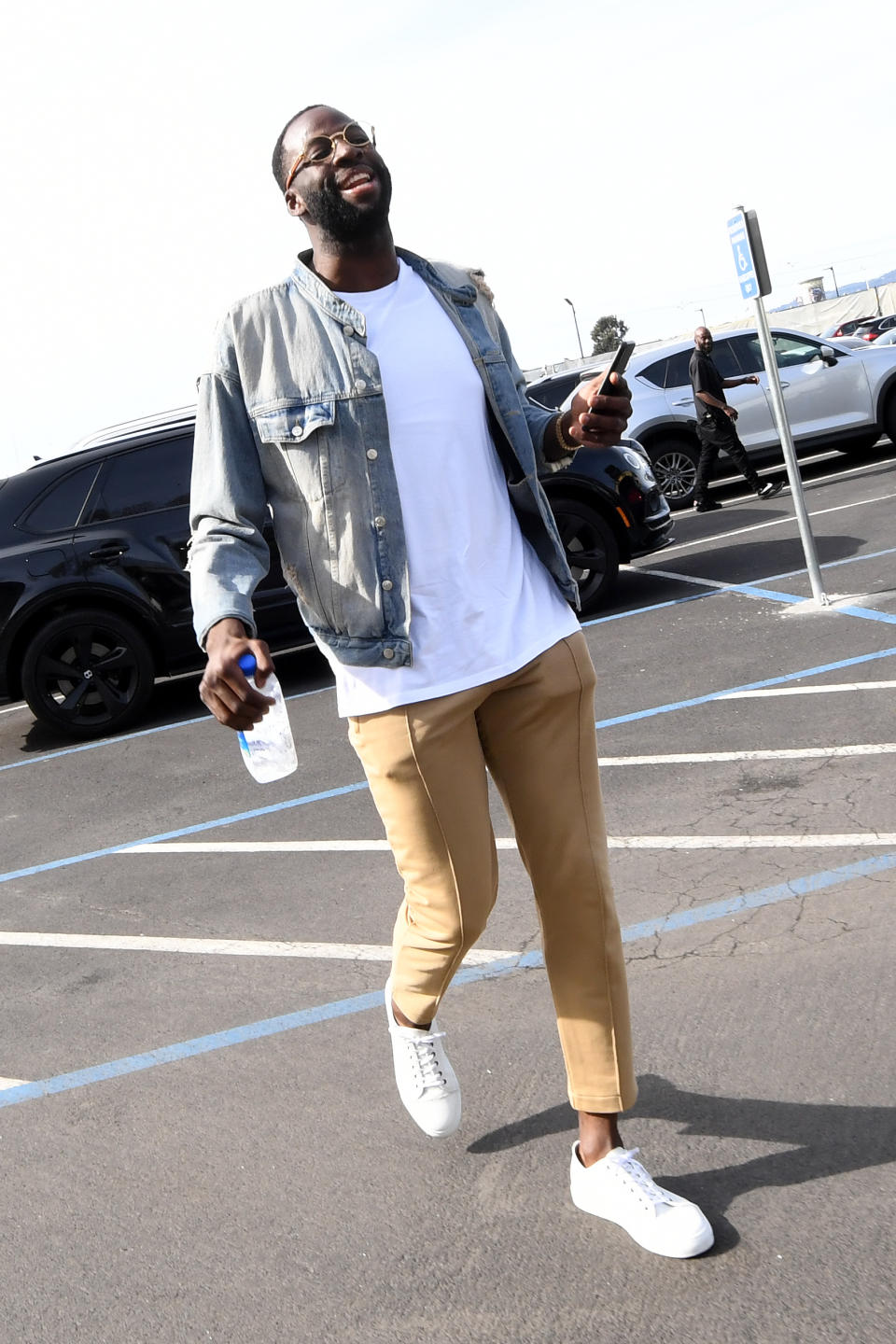 <p>Draymond Green wears a distressed jean jacket and plain white t-shirt on his way into the ORACLE Arena on March 31. </p>