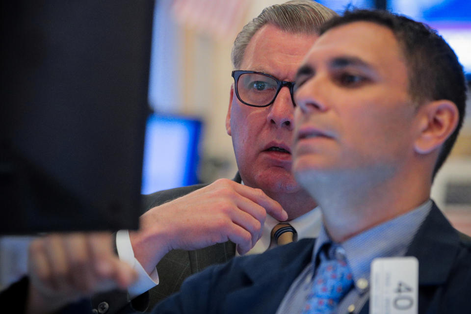 Traders work on the floor at the New York Stock Exchange (NYSE) in New York, U.S., June 24, 2019. REUTERS/Brendan McDermid