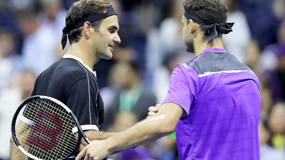 Roger Federer congratulates Grigor Dimitrov on his win after their quarterfinal Men's Singles match on day nine of the 2019 US Open. (Photo by Elsa/Getty Images)