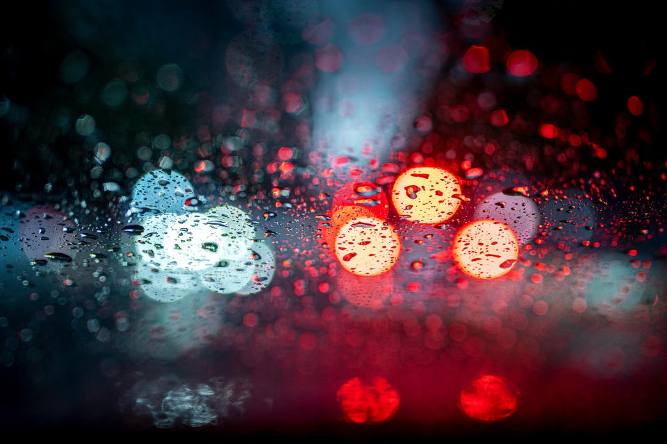 blurry tail lights through a rainy window