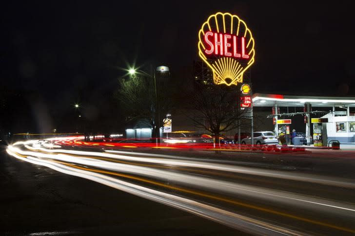 A vintage Shell sign is seen illuminated at a Shell gas station in Cambridge, Massachusetts, December 12, 2014. REUTERS/Brian Snyder