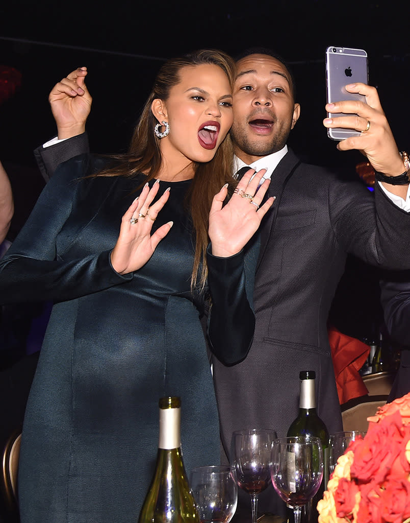 BEVERLY HILLS, CA - FEBRUARY 14:  Model Chrissy Teigen (L) and musician John Legend take a selfie at the 2016 Pre-GRAMMY Gala and Salute to Industry Icons honoring Irving Azoff at The Beverly Hilton Hotel on February 14, 2016 in Beverly Hills, California.  (Photo by Larry Busacca/Getty Images for NARAS)