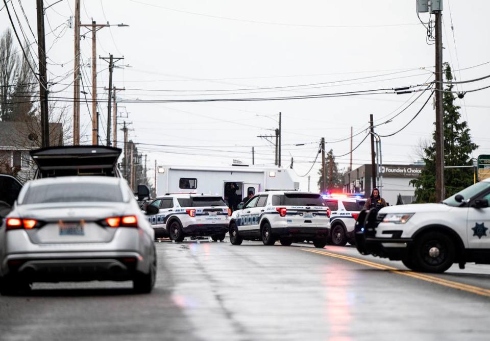 Crime scene technicians and the Pierce County Force Investigation Team investigate the scene where a person was shot and killed early Friday morning by a Tacoma Police Department officer after the person fled from police investigating them in a parked car near Pacific Avenue, and the shooting occurred at McKinley Avenue and East 57th Street in Tacoma, Wash. on Dec. 30, 2022.