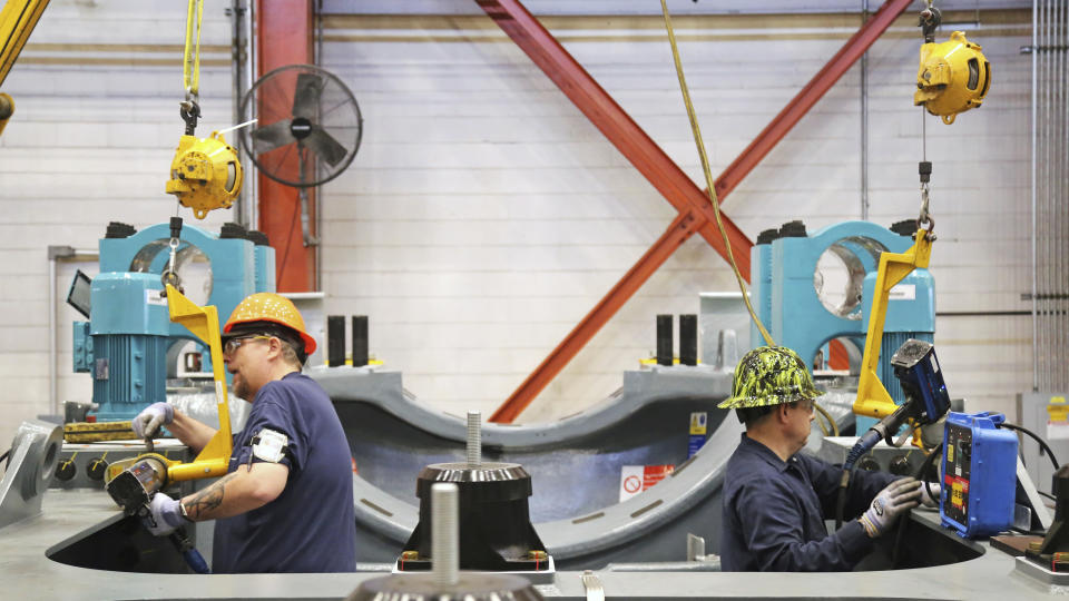 This undated image provided by GE Vernova shows two workers assembling key wind turbine components at the GE Vernova manufacturing facility in Pensacola, Florida. The company has received a record order for 674 turbines that will be used for the SunZia Wind Project in central New Mexico, which is expected to be the largest wind farm in the Western Hemisphere when it comes online in 2026. (Rebecca Shurtleff/GE Vernova via AP)