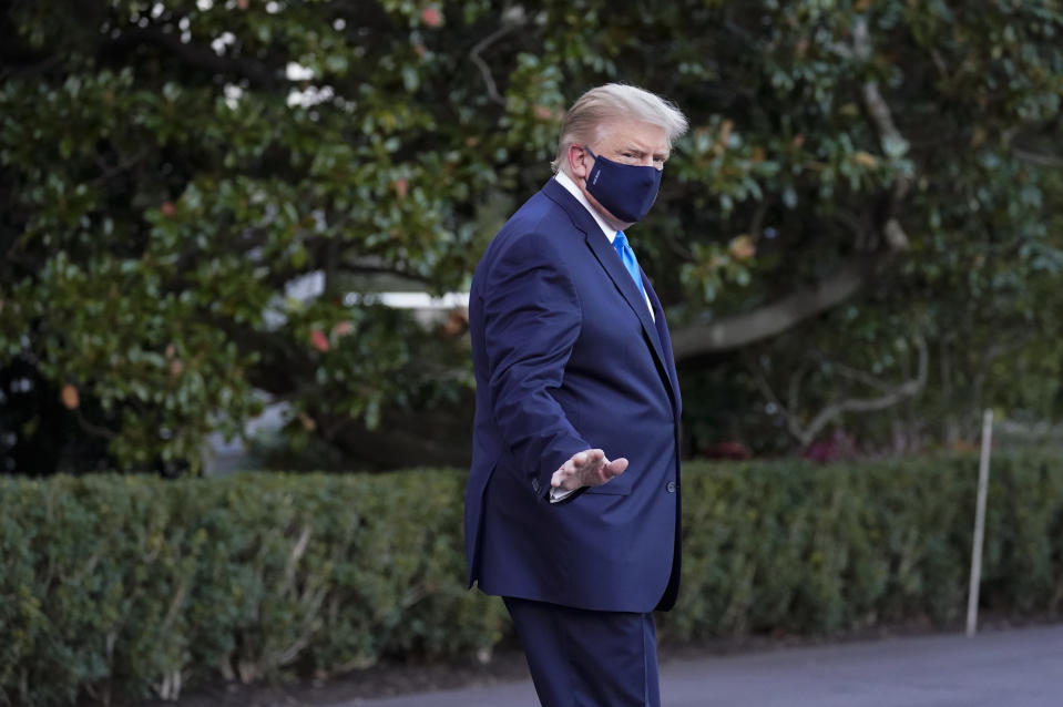 President Donald Trump waves to members of the media as he leaves the White House to go to Walter Reed National Military Medical Center after he tested positive for COVID-19, Friday, Oct. 2, 2020, in Washington. (AP Photo/Alex Brandon)