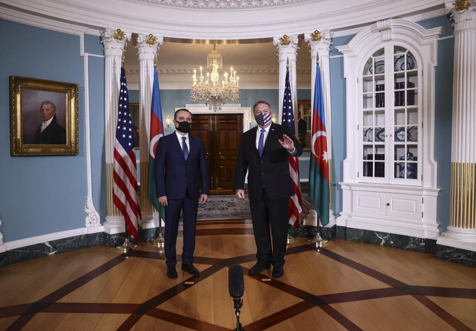 CORRECTS NAME TO AZERBAIJAN FOREIGN MINISTER JEYHAN BAYRAMOV - Secretary of State Mike Pompeo walks out to face reporters with Azerbaijan Foreign Minister Jeyhun Bayramov, prior to holding talks, Friday, Oct. 23, 2020 at the State Department in Washington. (Hannah McKay/Pool via AP)