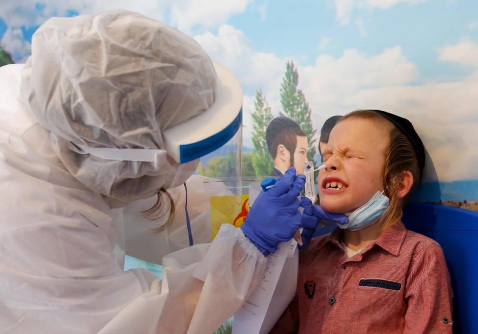 <div class="inline-image__caption"><p>An Israeli medical worker takes a swab test for COVID-19 at an ultra-Orthodox Jewish school in the central Israeli city of Rechovot.</p></div> <div class="inline-image__credit">Gil Cohen-Magen/AFP via Getty</div>