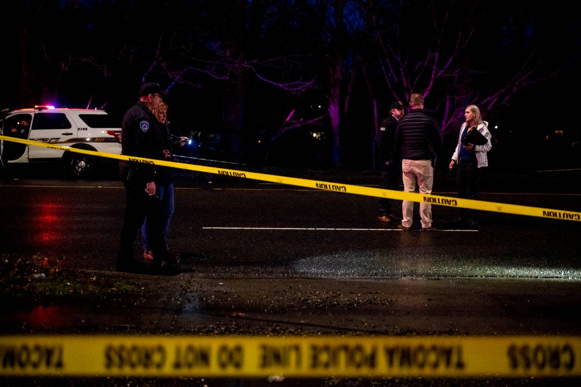 Detectives from the Tacoma Police Department begin to investigate the scene of a shooting near the intersection of Portland Avenue and East 40th Street on Thursday, Jan. 12, 2023, in Tacoma, Wash.