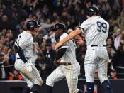 Oct 17, 2017; Bronx, NY, USA; New York Yankees shortstop Didi Gregorius (18) and right fielder Aaron Judge (99) celebrate scoring against the Houston Astros during the eighth inning in game four of the 2017 ALCS playoff baseball series at Yankee Stadium. Mandatory Credit: Robert Deutsch-USA TODAY Sports