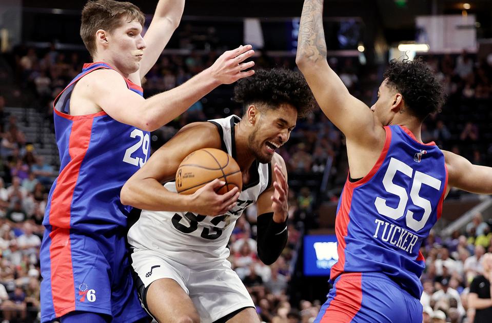 Utah Jazz guard <a class="link " href="https://sports.yahoo.com/nba/players/6762" data-i13n="sec:content-canvas;subsec:anchor_text;elm:context_link" data-ylk="slk:Johnny Juzang;sec:content-canvas;subsec:anchor_text;elm:context_link;itc:0">Johnny Juzang</a> (33) battles for position between Philadelphia 76ers forward Azuolas Tubelis (29) and Philadelphia 76ers Jordan Tucker (55) as the Utah Jazz and Philadelphia 76ers play in Summer League action at the Delta Center in Salt Lake City on Wednesday, July 5, 2023. 76ers won 104-94. | Scott G Winterton, Deseret News