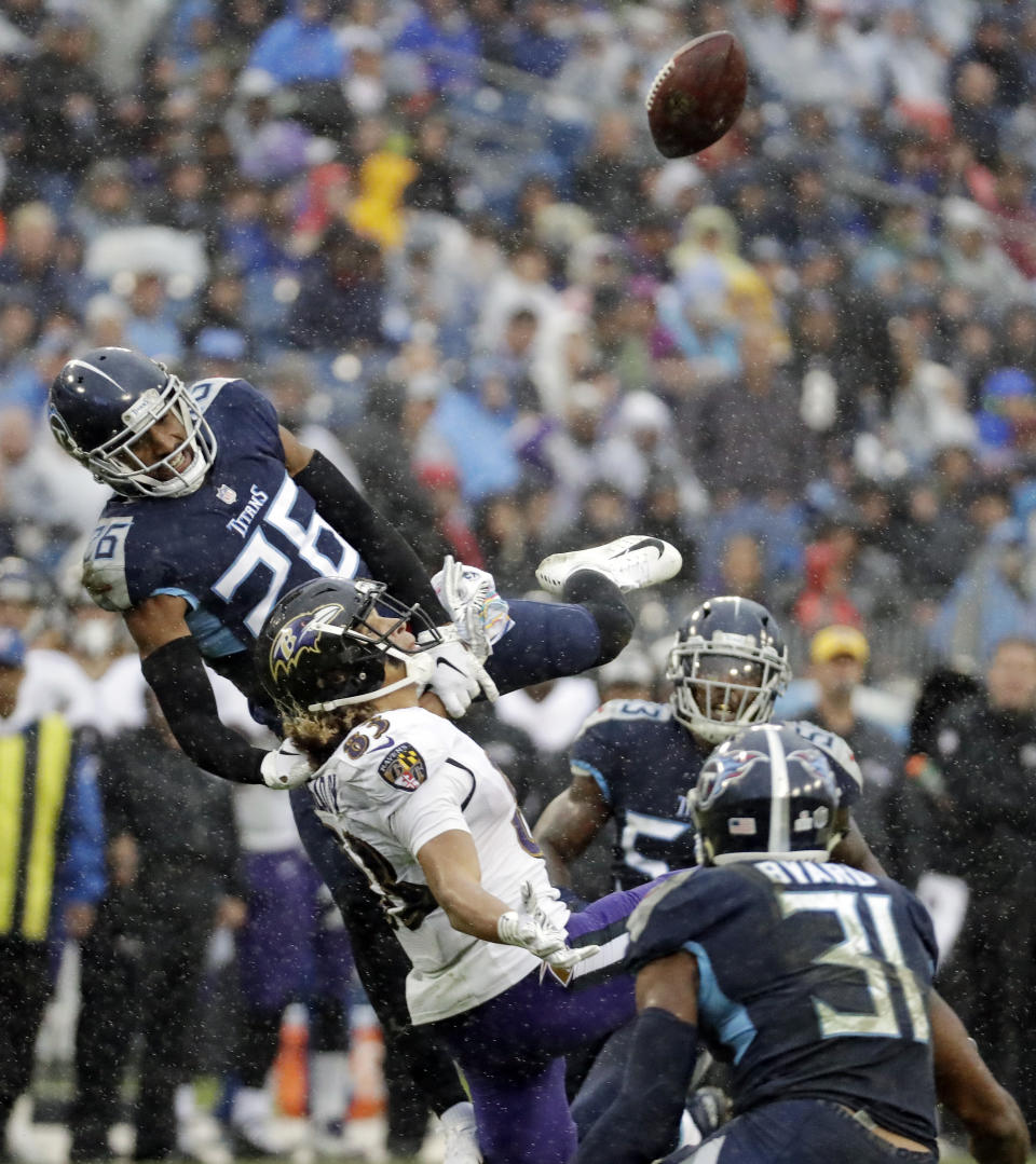 A pass intended for Baltimore Ravens wide receiver Willie Snead IV (83) bounces up in the air as Tennessee Titans safety Kevin Byard (31) moves in to intercept it in the first half of an NFL football game Sunday, Oct. 14, 2018, in Nashville, Tenn. (AP Photo/James Kenney)